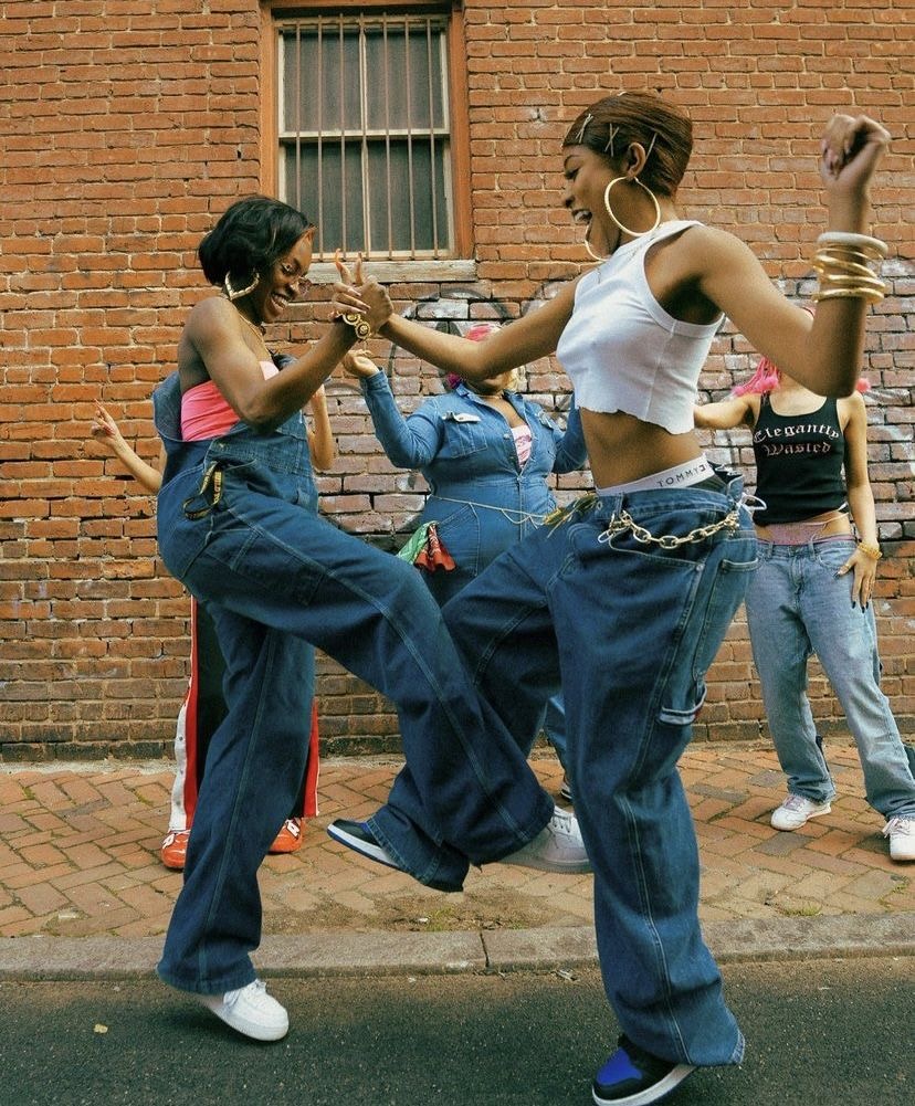 Women dancing together, celebrating style and community